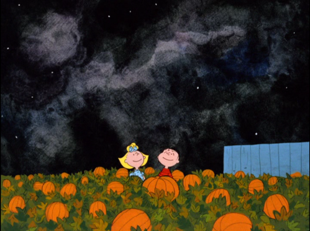 Lucy and Linus waiting in the pumpkin patch for The Great Pumpkin, looking up at the night sky and smiling.